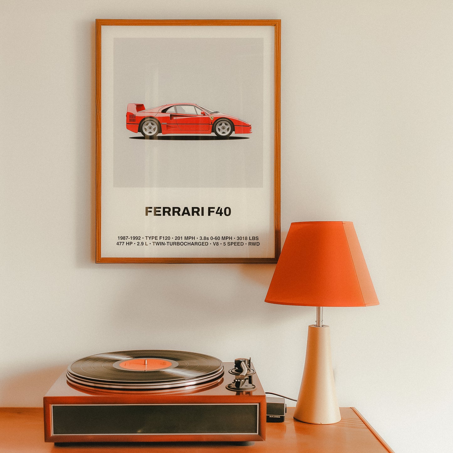 Framed poster illustration of the Ferrari F40 in side profile, showcasing the iconic red supercar against a light gray background. This fine art wall print highlights Ferrari’s classic design elements, including the rear spoiler, side vents, and aerodynamic lines. Perfect as a minimalist automotive poster or wall art for car enthusiasts, featuring F40 specifications and a stylish aesthetic ideal for collectors and fans of luxury cars.