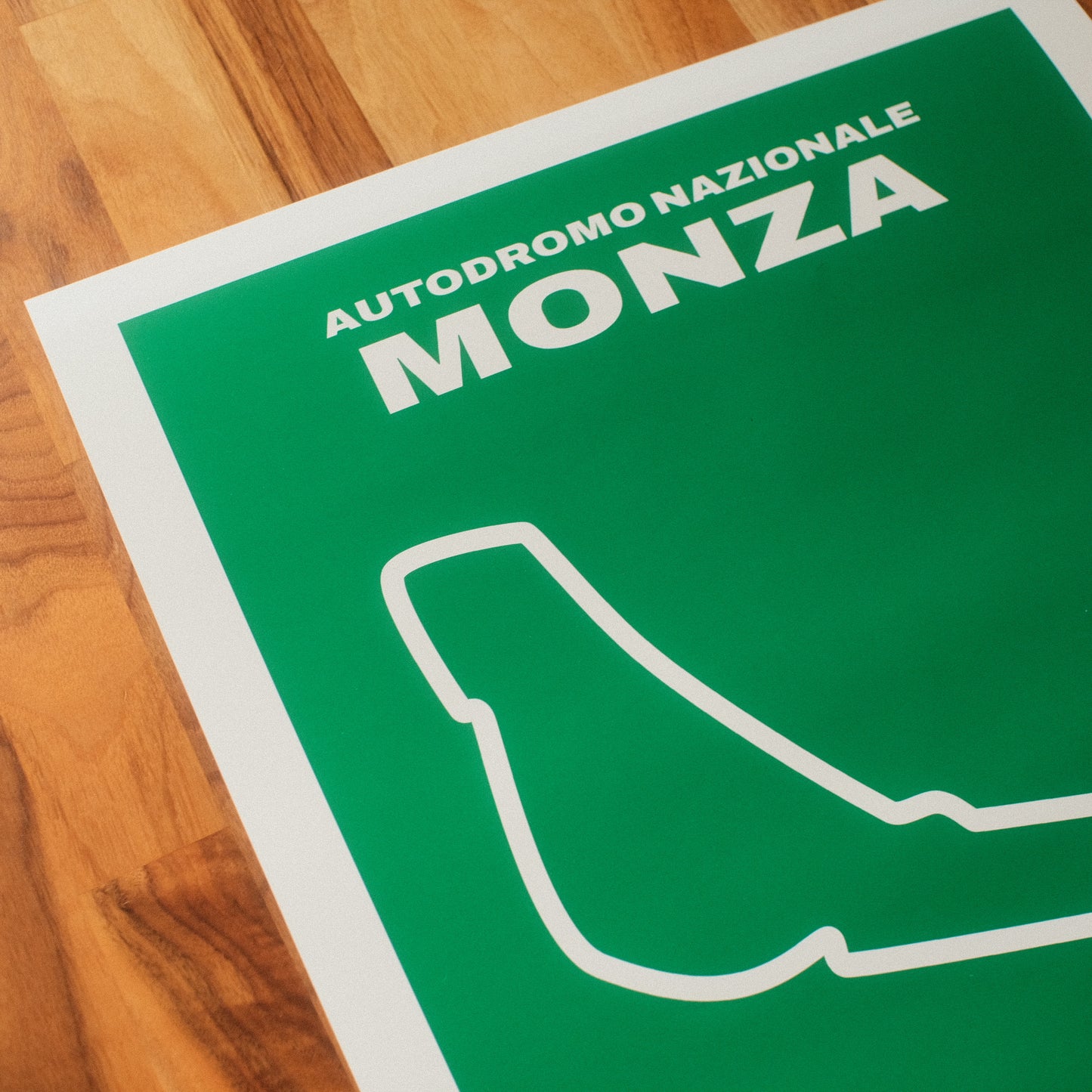 Formula 1 poster of Autodromo Nazionale Monza track and grand prix, featuring a vibrant green background with a minimalist white outline of the iconic F1 track layout. Midcentury modern space wall art poster.