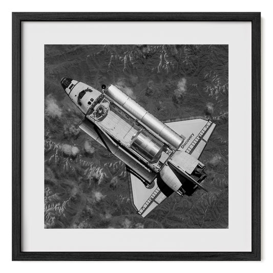 Space Shuttle Discovery as it approaches the International Space Station during the historic STS-131 mission. Photography space print framed in oak and tempered glass. Fine art photo print by Airdusk.